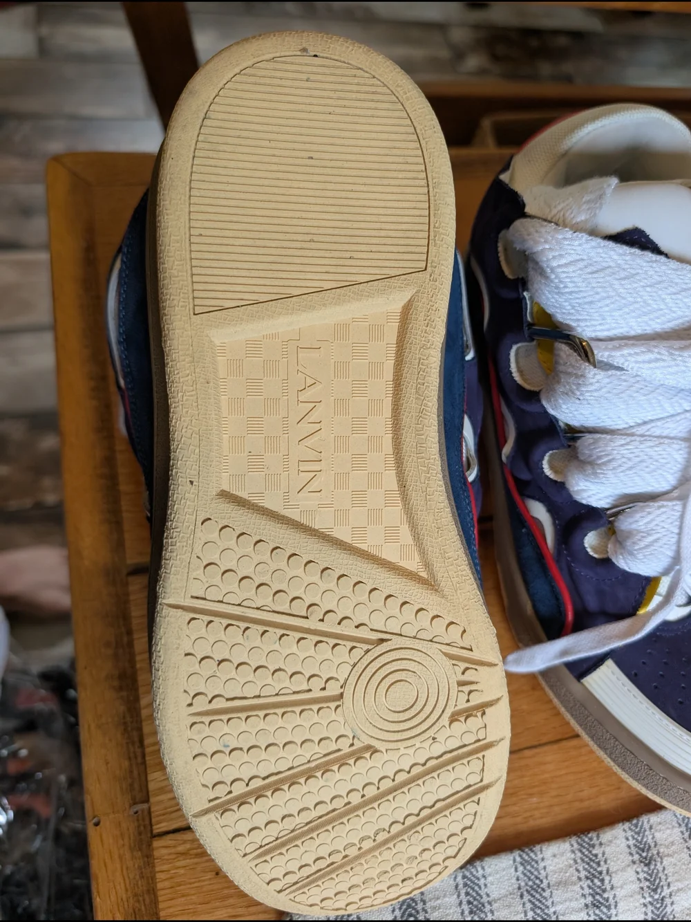 Lanvin Curb Sneakers in a distinct Navy Blue, White, Red, and Yellow colorway.
